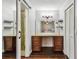 Elegant dressing area leading to Primary bath with wood cabinets, granite counters and stylish shower at 1026 Manchester Cir, Winter Park, FL 32792