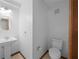 Half-bathroom with a classic white pedestal sink and modern toilet at 11160 Sylvan Pond Cir, Orlando, FL 32825
