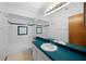 Bathroom featuring retro-style fixtures, a tiled shower-tub, and a teal countertop at 11160 Sylvan Pond Cir, Orlando, FL 32825