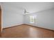 Comfortable bedroom with wood floors and a view of the lake at 11160 Sylvan Pond Cir, Orlando, FL 32825