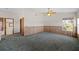 Vaulted bedroom with wood paneling, fan, carpet, and natural light at 11160 Sylvan Pond Cir, Orlando, FL 32825