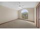 Bedroom with carpet, fan, and arched window at 11160 Sylvan Pond Cir, Orlando, FL 32825