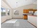 Bright dining area featuring neutral tile flooring, a pendant light, and a view of the lake at 11160 Sylvan Pond Cir, Orlando, FL 32825