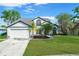 Charming two-story home featuring a well-manicured lawn, mature trees, and a spacious two-car garage at 11160 Sylvan Pond Cir, Orlando, FL 32825