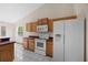 Bright kitchen with light wood cabinets, white appliances, and neutral countertops at 11160 Sylvan Pond Cir, Orlando, FL 32825