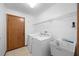 Laundry room with a washer, dryer, utility sink, and wire shelving at 11160 Sylvan Pond Cir, Orlando, FL 32825