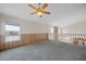 Upper loft area with carpet, fan, view of water, and natural light at 11160 Sylvan Pond Cir, Orlando, FL 32825