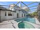 Pool area with a hot tub and a view of the back of the house, all enclosed in a screen at 11160 Sylvan Pond Cir, Orlando, FL 32825