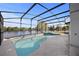 Screened-in pool and spa with lake views at 11160 Sylvan Pond Cir, Orlando, FL 32825