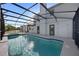 Screened-in pool area with a pool, spa, and access doors to the home at 11160 Sylvan Pond Cir, Orlando, FL 32825
