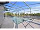 Screened-in pool area with a pool, spa, and view of the lake at 11160 Sylvan Pond Cir, Orlando, FL 32825
