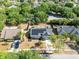 Aerial view of a home with solar panels, surrounded by lush greenery and neighboring houses at 1134 Shaffer Trl, Oviedo, FL 32765