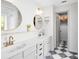 Bright bathroom with double sinks, gold fixtures, and a black and white checkered floor at 1134 Shaffer Trl, Oviedo, FL 32765