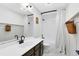 The bathroom has a large sink and vanity, with shower and bath featuring white shower curtains at 1134 Shaffer Trl, Oviedo, FL 32765