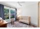 This cozy bedroom features a ceiling fan, area rug, and a window offering an exterior view at 1134 Shaffer Trl, Oviedo, FL 32765
