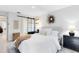 Well-lit bedroom featuring a bed with white linens and modern black accents at 1134 Shaffer Trl, Oviedo, FL 32765