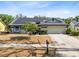 Charming single-story home featuring solar panels, a two-car garage, and a well-maintained front yard at 1134 Shaffer Trl, Oviedo, FL 32765