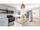 Well-lit kitchen with stainless appliances, light wood floors, and a butcher block island at 1134 Shaffer Trl, Oviedo, FL 32765