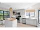 Bright kitchen with white cabinetry, stainless steel appliances, and butcher block island countertop at 1134 Shaffer Trl, Oviedo, FL 32765