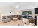 Cozy living room featuring a plush sectional sofa and glass doors leading to outdoor patio at 1134 Shaffer Trl, Oviedo, FL 32765