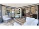 Screened-in patio with TV, seating, and view into the kitchen and living room at 1134 Shaffer Trl, Oviedo, FL 32765