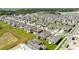 An aerial view of the neighborhood and surrounding area showing the layout of the homes and proximity to natural areas at 1163 James Paul Rd, Davenport, FL 33837