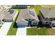 An aerial view shows solar panels on the roof of a modern home with manicured lawns at 1163 James Paul Rd, Davenport, FL 33837