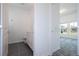 Modern bathroom with tiled floors and a view into an adjacent bedroom at 1163 James Paul Rd, Davenport, FL 33837