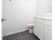 Simple bathroom featuring a toilet, a sink and vanity, and tiled floors at 1163 James Paul Rd, Davenport, FL 33837
