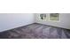 Bedroom with plush carpeting and bright windows showing a partial view of the neighborhood at 1163 James Paul Rd, Davenport, FL 33837