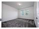 Bright bedroom with two windows offers natural light and cozy carpet at 1163 James Paul Rd, Davenport, FL 33837
