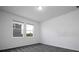 Bright bedroom features neutral carpeting and two windows for natural light at 1163 James Paul Rd, Davenport, FL 33837