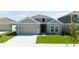 Beautifully landscaped single Gathering home with attached two car garage and neutral toned color scheme at 1163 James Paul Rd, Davenport, FL 33837
