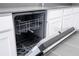 Close-up of an open dishwasher with a stainless steel interior in a modern kitchen setting at 1163 James Paul Rd, Davenport, FL 33837