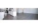 Open kitchen and living space with white cabinets, stainless appliances, and sleek tile flooring at 1163 James Paul Rd, Davenport, FL 33837