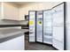 Spacious kitchen showcasing a large refrigerator, white cabinets, and a sleek design at 1163 James Paul Rd, Davenport, FL 33837