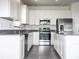 Well-lit kitchen with white cabinetry, stainless steel appliances, and a modern design at 1163 James Paul Rd, Davenport, FL 33837