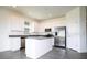 Modern kitchen with white cabinetry, stainless steel appliances, and a center island for seating at 1163 James Paul Rd, Davenport, FL 33837