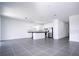 Bright and open-concept living area with sleek tile floors and an adjacent kitchen area at 1163 James Paul Rd, Davenport, FL 33837