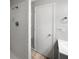 Bathroom featuring a shower with white tiles, a sink, and a towel rack at 1249 12Th St, Clermont, FL 34711