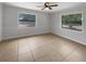Bright bedroom featuring two windows and tile flooring offering ample natural light at 1249 12Th St, Clermont, FL 34711