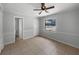 Bedroom with tile flooring, a ceiling fan, and view to bathroom at 1249 12Th St, Clermont, FL 34711