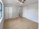 Bedroom with tile flooring, a ceiling fan, and a closet at 1249 12Th St, Clermont, FL 34711