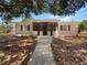 Charming single-story home with a screened-in porch and walkway leading to the front door at 1249 12Th St, Clermont, FL 34711