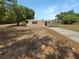 Well-maintained single-story home with a long driveway and covered parking area at 1249 12Th St, Clermont, FL 34711