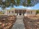 Charming single-story home with a screened-in porch and walkway leading to the front door at 1249 12Th St, Clermont, FL 34711