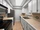 Efficient kitchen with white cabinets, black appliances, and tile countertops at 1249 12Th St, Clermont, FL 34711