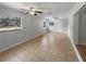 Spacious living room with tile floors, ceiling fans, and natural light from two windows at 1249 12Th St, Clermont, FL 34711