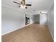 Open living room featuring tile flooring, ceiling fans, and a partial view of the kitchen at 1249 12Th St, Clermont, FL 34711