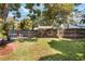 Lush backyard with a fire pit, mature trees, and ample space for outdoor activities at 125 E Miller St, Orlando, FL 32806